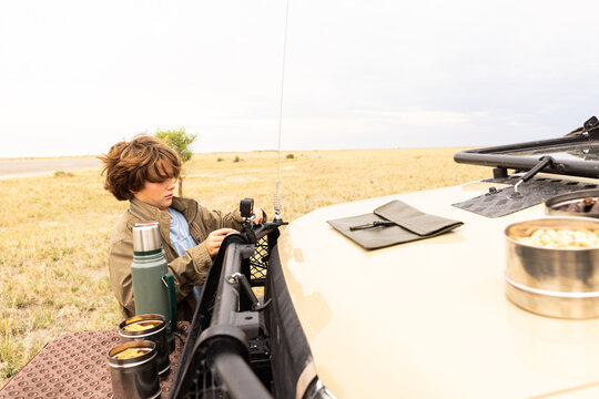 young boy preparing to use camera, Okavango Delta, Botswana, Africa