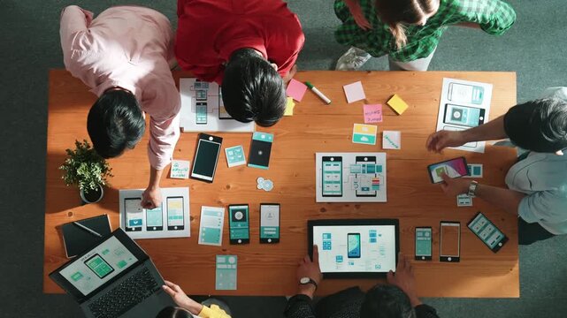 Top view of smart software developer planning software development. Skilled programmer team brainstorming and designing Ux UI design for mobile phone interface or digital creative design. Convocation.