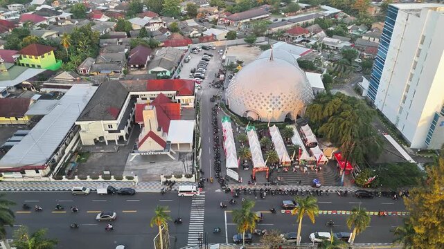 Drone Footage Capturing Religious Tolerance Between Islamic Mosque and Christian Church in Busy Indonesian City Landscape