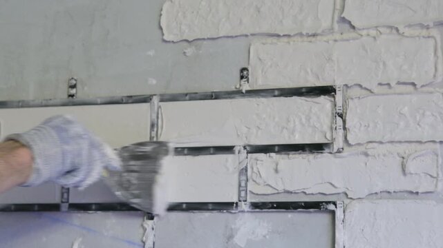 male hands making bricks using a stencil