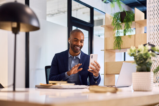 Mid adult black man having video call on smartphone