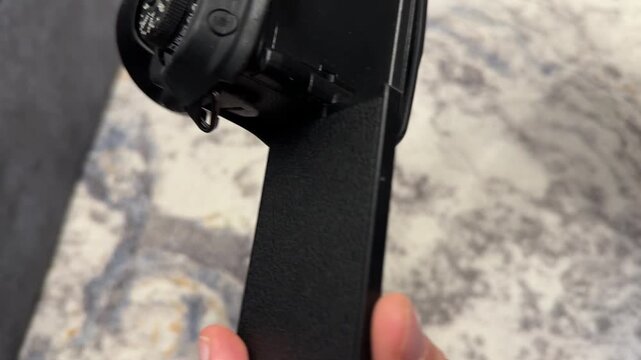 Hand rotating flip display on digital camera close up, photography equipment adjustment and content creation technology concept