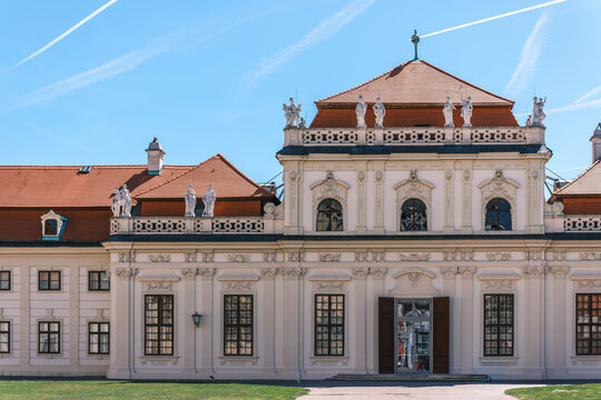 View of the baroque facade and statues of the Belvedere Palace under a clear blue sky in Vienna, Vienna, Austria.