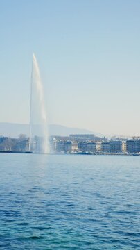 GENEVA, SWITZERLAND - MARCH 19, 2026: Static shot of UN Palais des Nations entrance with flags and passing black van