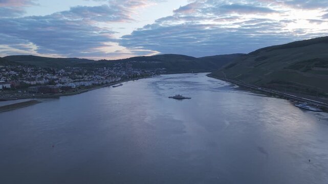 Cinematic aerial view of the Rhine River in Rudesheim at blue hour with cruise ship