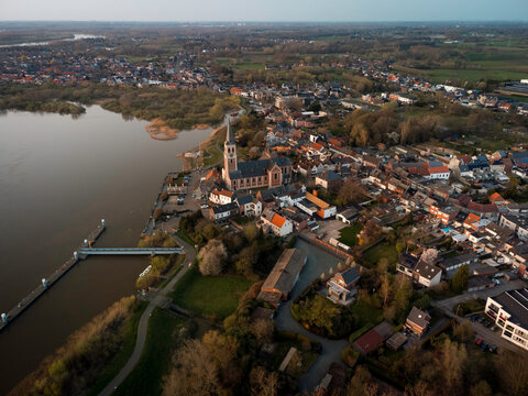 Aerial View of a Flemish Town: Historic Church and Residential Areas by the River
