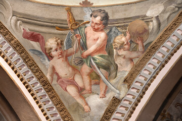 Obraz premium CREMA, ITALY - MARCH 20, 2026: The fresco of baroque angels with the symbols of David the church Santuario di Santa Maria della Croce by brothers Giuseppe and Giovanni Antonio Torricell from year 1762