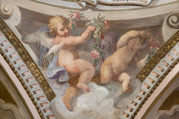 Obraz premium CREMA, ITALY - MARCH 20, 2026: The fresco of angels with the flowers the church Santuario di Santa Maria della Croce by Giacomo Parravicino - il Gianolo (1702).