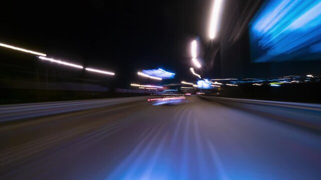Nighttime Drive Through Illuminated Road Lights With Motion Blur Effects. Hyperlapse Road Trip. Driving Along a Highway at Night Featuring Bright Streetlights Overhead and Motion Blur Effects.