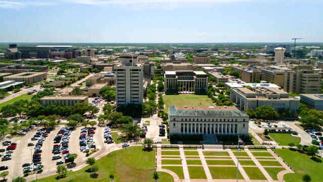 Aerial view of green campus lawn office buildings and parking in College Station Texas USA