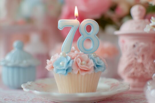 Elegant birthday cupcake decorated with pastel roses and number candles for 78th celebration