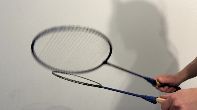Close up of badminton racket in hands, sport equipment and activity concept, preparation for game and movement
