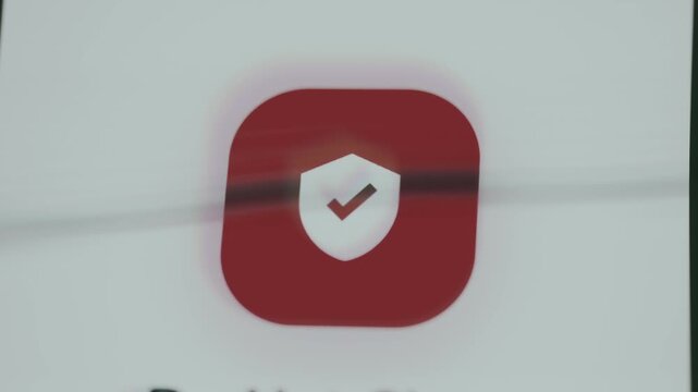 Security symbol, white shield with a red checkmark representing protection against online threats