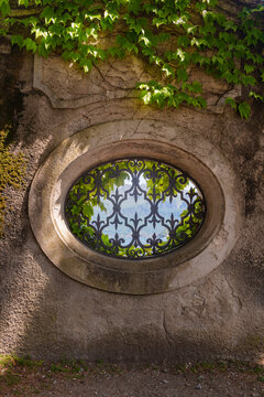 window in old stone wall by Lake Como, Italy