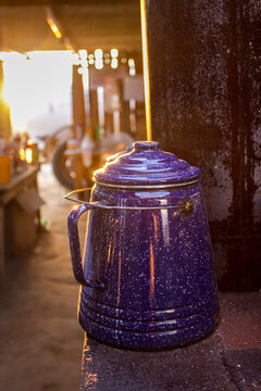 Blue enamel coffee pot by wood stove 