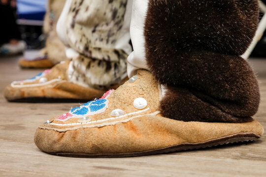 Beaded moccasin with fur cuff in traditional Native regalia