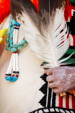 Feather and turquoise necklace detail on traditional pueblo regalia