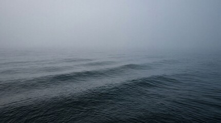 Fototapeta premium Professional Dense Morning Mist Hanging Over Gently Rolling Ocean Sweeping Dramatic Seascape Photography Image