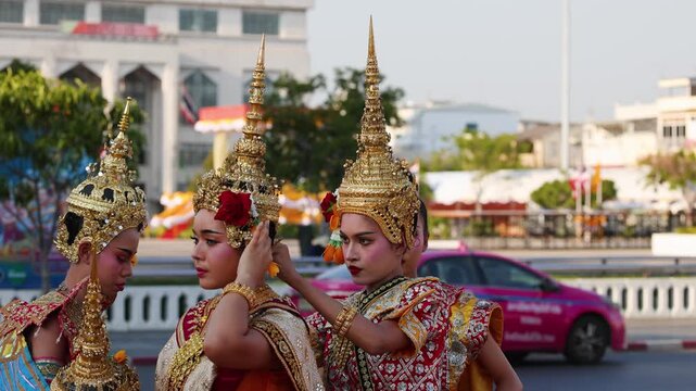 Thai Traditional Dancers Adjusting Golden Chada Headdresses in Bangkok City