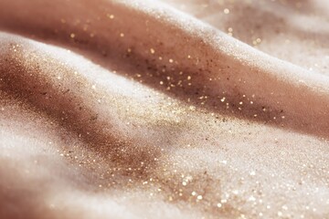 Fototapeta premium Close-up of sparkling gold glitter on soft pink fabric surface
