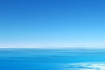 Obraz premium Tranquil ocean and clear blue sky horizon with soft clouds