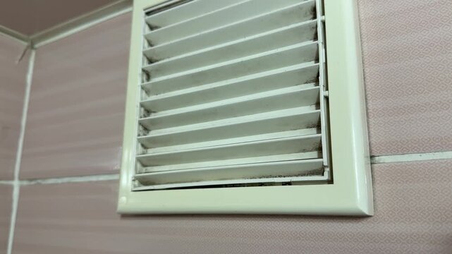 bathroom exhaust fan grille in close up, ventilation system removing humid air and odors, home air circulation concept