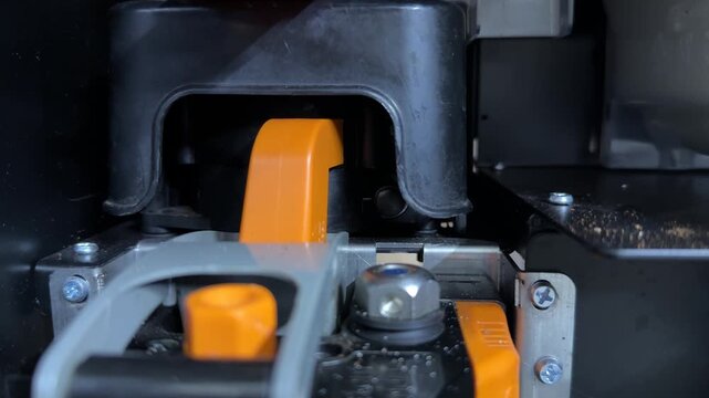 metal fastening nut rotating on coffee vending machine brewing unit, internal mechanism in motion close up