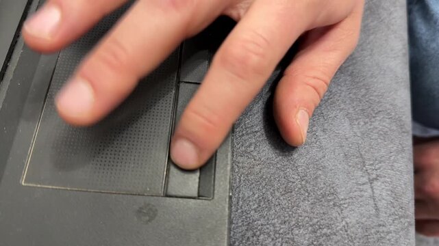 Hand using laptop touchpad close up, computer navigation and remote work technology concept
