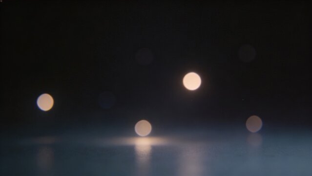 Abstract glowing orbs on dark surface