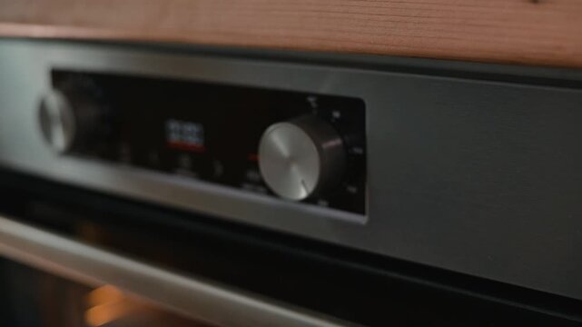 A person adjusts the temperature dial on an oven while preparing to bake. The close-up shots showcase the hands and the control panel of the oven in a domestic kitchen setting