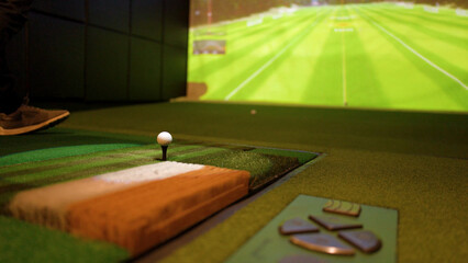 Fototapeta na wymiar Close Up of Golf Ball on Tee in Indoor Simulator