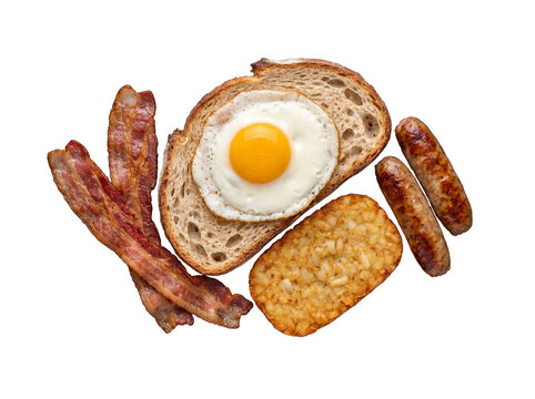 Classic full English breakfast elements including fried egg, crispy bacon, golden hash brown, and savory sausages.