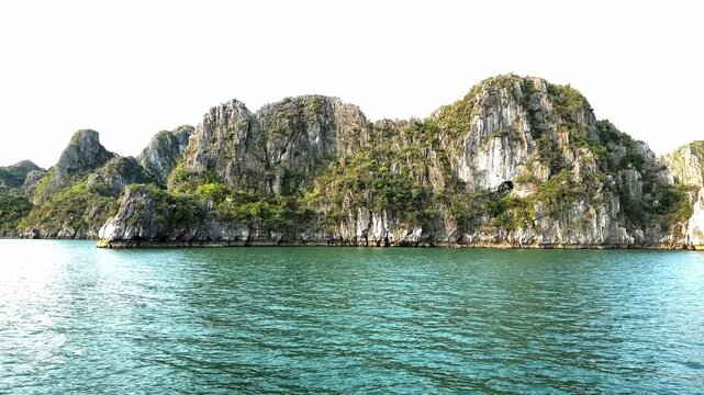 Scenic limestone karsts islands in Halong bay Vietnam featuring calm emerald water and tropical nature