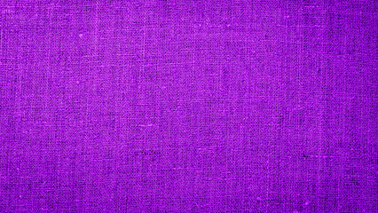 Fototapeta premium Bright purple fabric draped on a surface during a crafting session in a sunny workspace