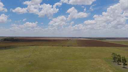 Fototapeta premium Aerial View of Expansive Australian Farmland Under a Cloudy Blue Sky