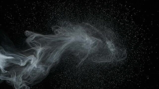 Cinematic white powder burst drifting through black space with elegant swirling particles and copyspace in 4K