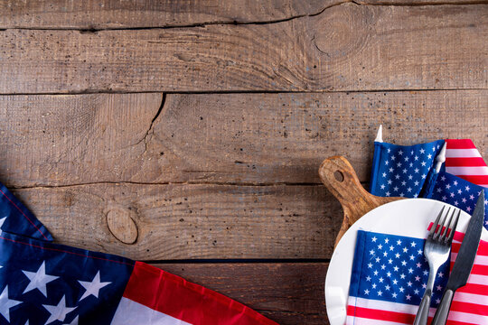 USA patriotic table setting with american flag, plate and decoration in national flag colors on white background. Independence Day. Happy Memorial Day dinner menu background top view copy space