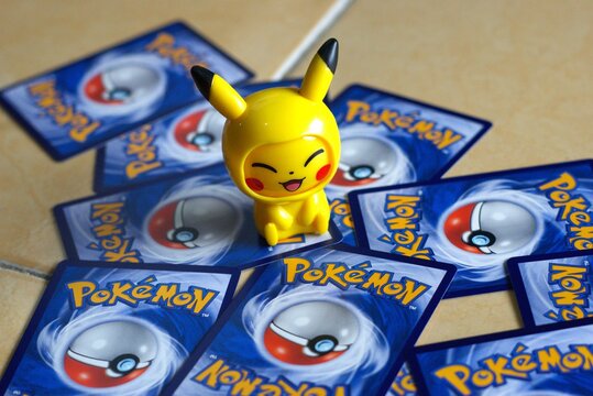 pikachu figurine on pokemon trading cards background