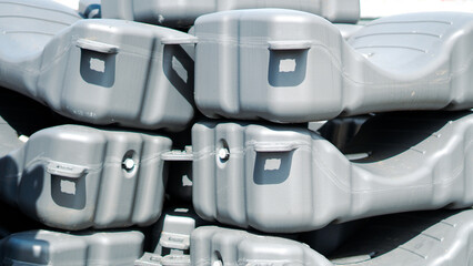 A stack of gray modular plastic floating dock sections in a harbor area © Наталья Добровольска