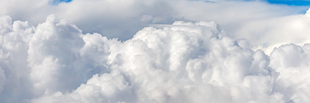 Clouds cover the sky during the day with sunlight shining through on a bright afternoon in a clear blue sky