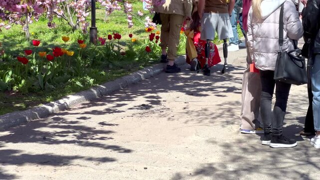 Amputee veteran walking with prosthetic leg in park