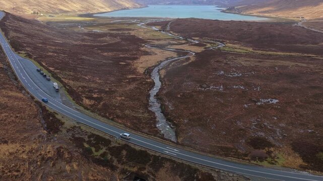 Scenic aerial view revealing the eas a' bhradain waterfall and a meandering stream flowing towards loch ainort on the isle of skye, scotland