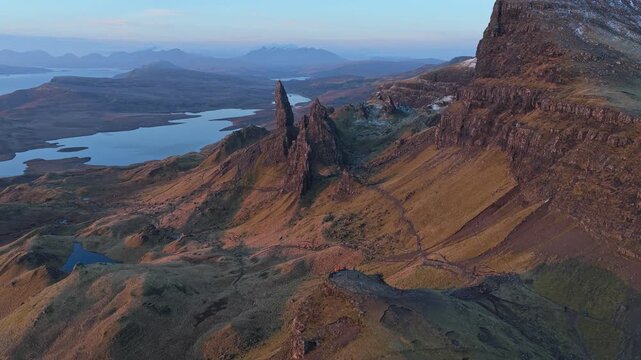 Majestic aerial perspective of the old man of storr on the isle of skye. The rock formations glow with the warm light of sunrise or sunset