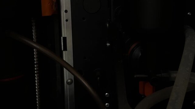 Close up moving brew group inside coffee vending machine, automatic beverage mechanism and maintenance concept