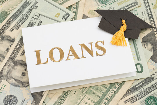 Student Loans message on card with grad cap over money