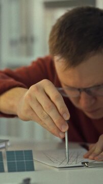 A bespectacled young engineer researches solar energy, examining solar panels mounted on private home rooftops. The sustainable study highlights green power adoption, advancing eco-friendly living
