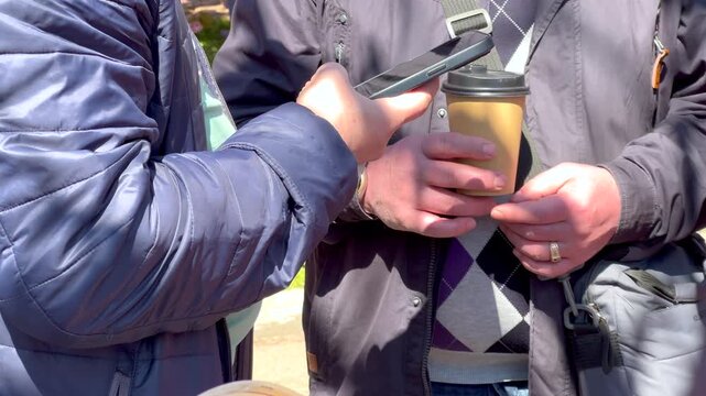 Person scanning qr code for contactless payment with smartphone