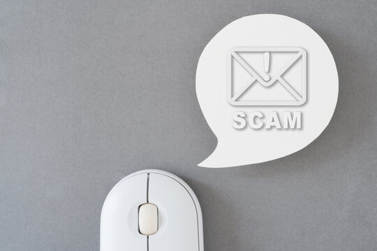 For investment scam, fraud and Ponzi scheme concept,  prohibit scam icon inside envelope on real white speech bubble paper cut with computer mouse on grey background