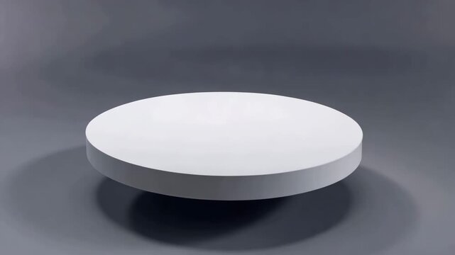 Minimalist rotating white disc platform levitates gently in studio with soft lighting and shadow.