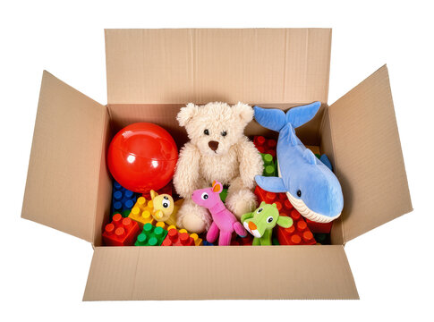 Isolated open cardboard box full of colorful children's toys ready for playtime or donation